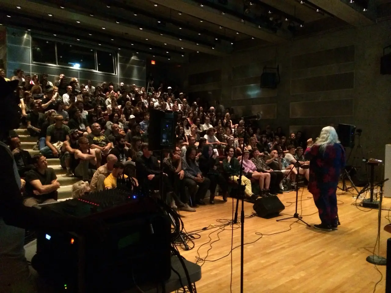 DJMREX live with Genesis Breyer P-Orridge at MOCA: a packed theatre, Genesis at the microphone, the rig in the foreground
