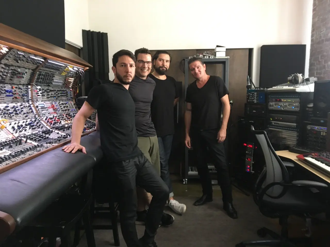 Ken, Douglas J. McCarthy, Cyrus and Brad posing in front of the modular console in the Los Angeles studio