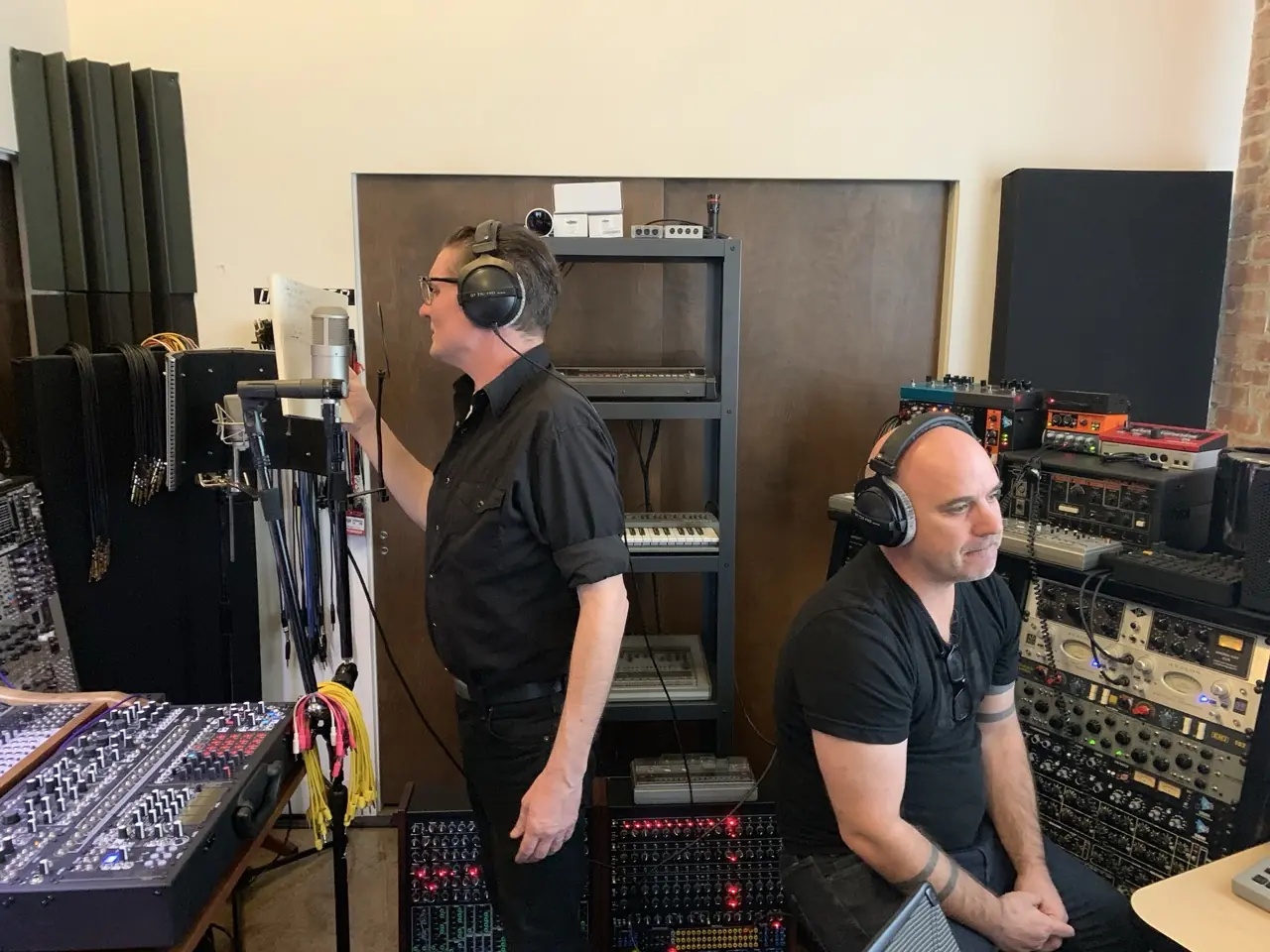 Douglas J. McCarthy and Bon Harris in headphones in the Los Angeles studio