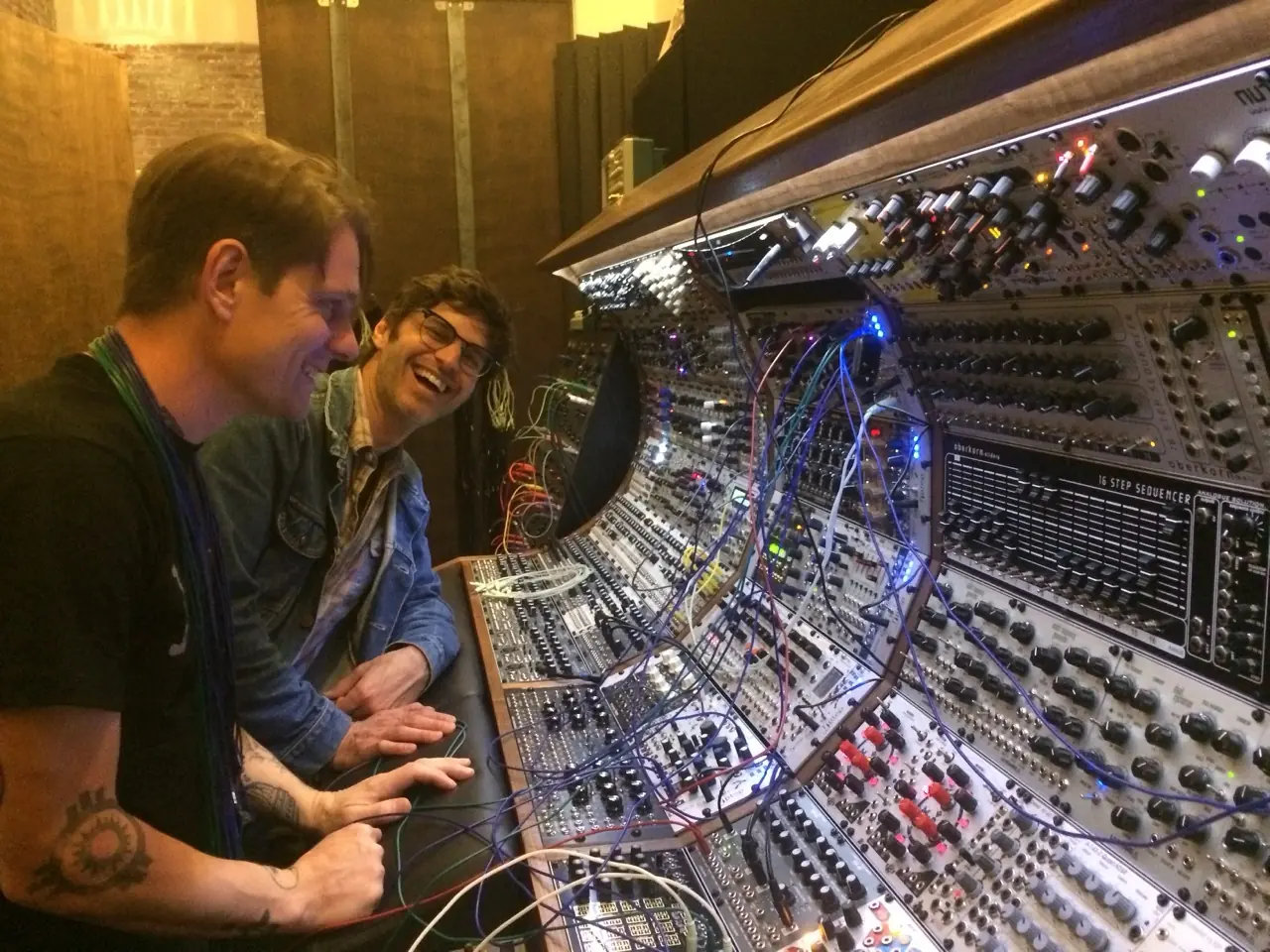 Rodent and Tony Rolando of Make Noise laughing at the big modular in the Los Angeles studio