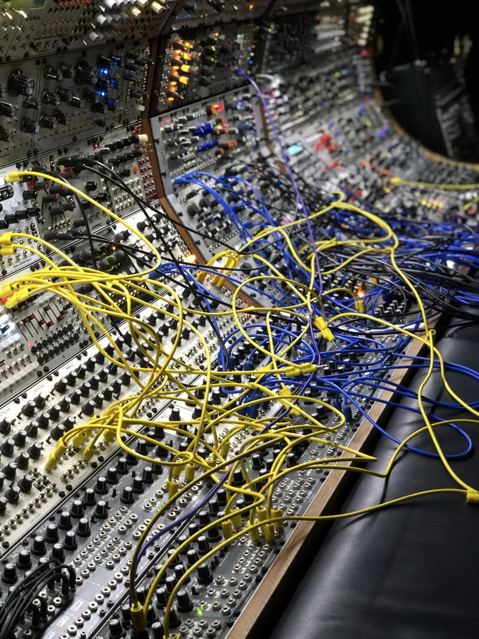 Close-up of a modular synth patched with yellow cables