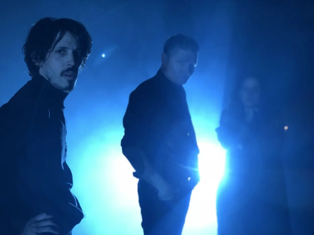 Two men in deep blue light