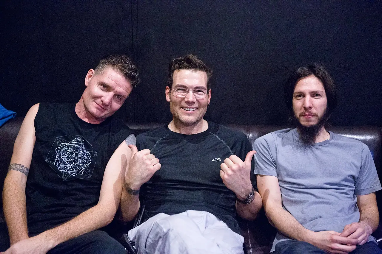 Ken, Douglas J. McCarthy and Cyrus on a couch backstage at the DJMREX show with Skinny Puppy