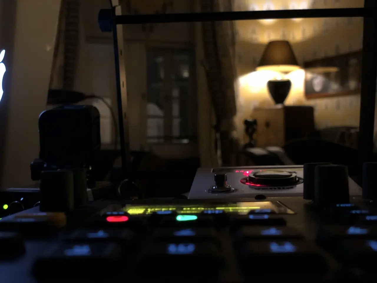 Gear on a table in a dim, lamp-lit room