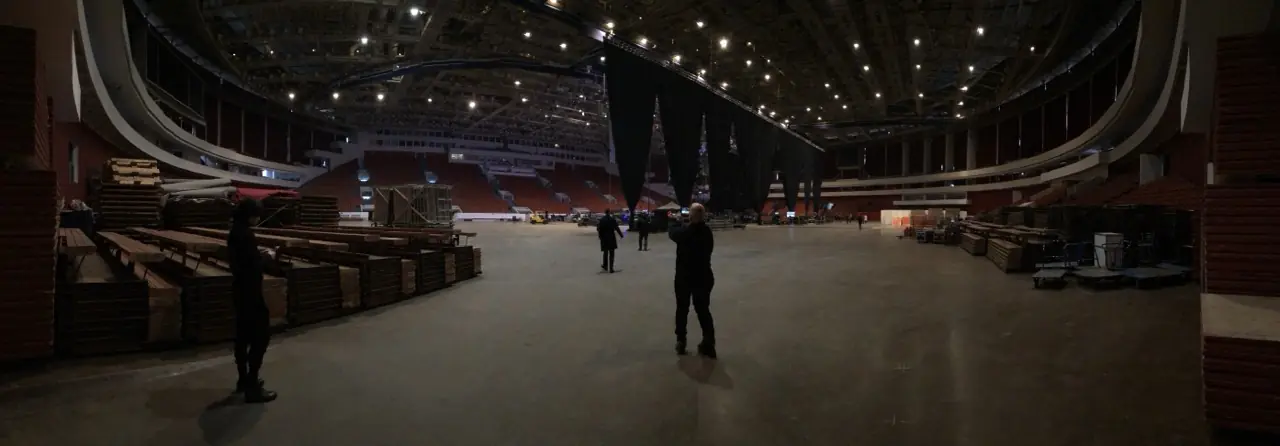 A wide, dark hall before a show